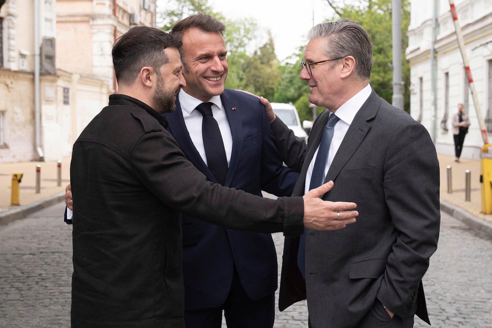Ukrainian President Volodymyr Zelensky, left, Britain's Prime Minister Keir Starmer, right, and French President Emmanuel Macron, center, talk during a meeting in Kyiv, Ukraine, Saturday, May 10, 2025. (Stefan Rousseau/PA via AP, Pool)