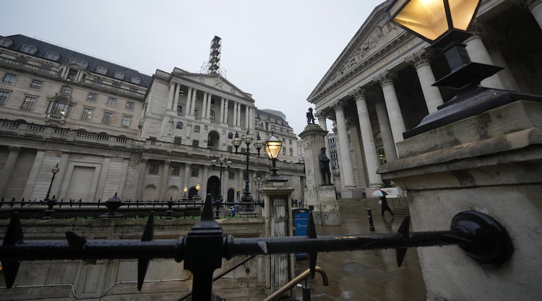 FILE -A man walks in front of the Bank of England, at the financial district in London, Feb. 5, 2026 (AP Photo/Kin Cheung, File)