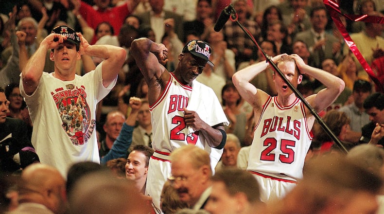 I3 Jun 1997:  Michael Jordan #23 of the Chicago Bulls celebrates with teammates Jud Buechler and Steve Kerr #25 after winning game six of the NBA Final against the Utah Jazz at the United Center in Chicago, Illinois. The Bulls defeated the Jazz 90-86..   Mandatory Credit: Jonathan Daniel  /Allsport