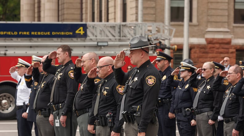 Officers pay respects during a rifle salute at Public Safety Forces Day on Friday, May 2, 2025, near the Clark County Public Safety Memorial. JOSEPH COOKE/STAFF