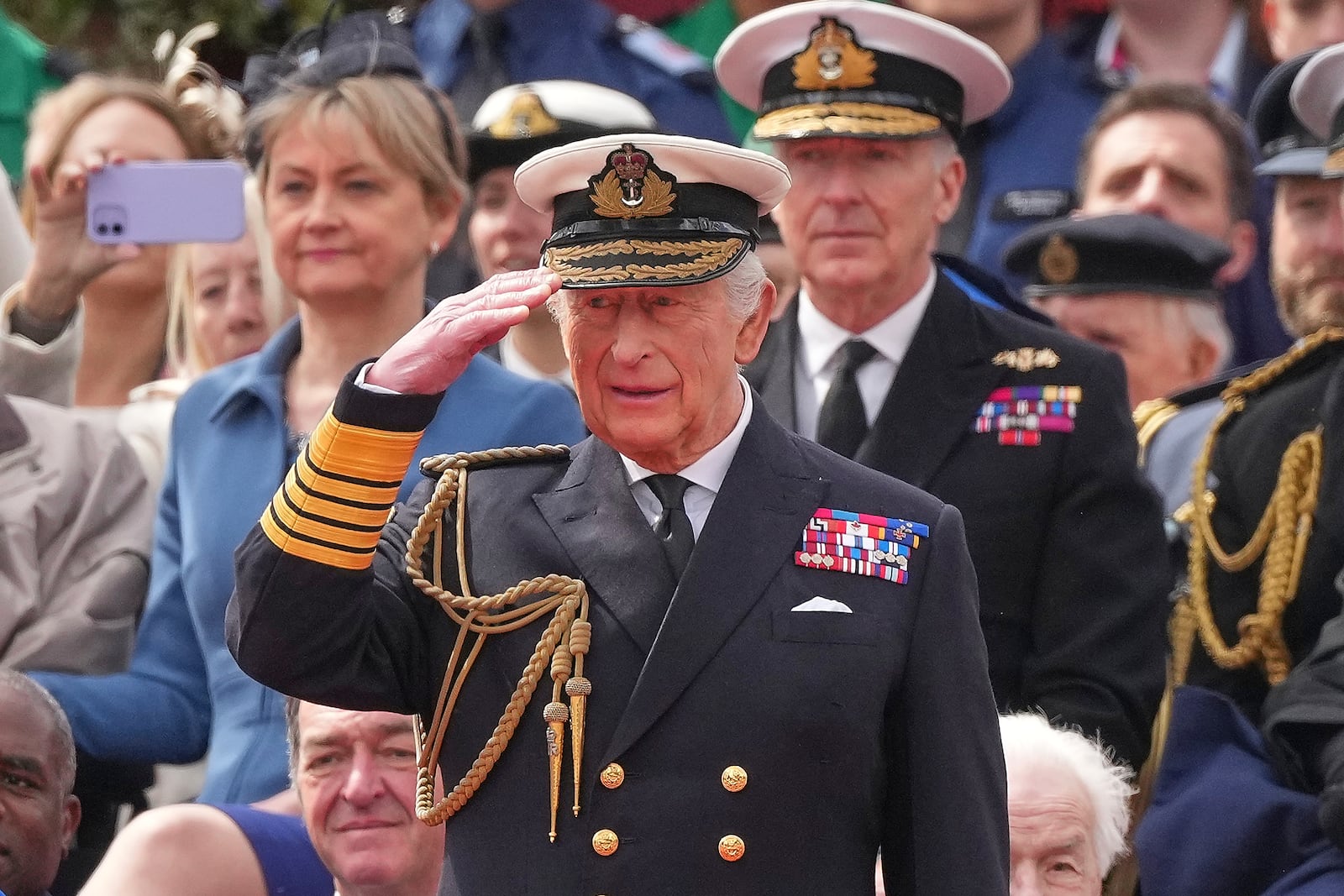 Britain's King Charles III salutes as he watches the V-E Day 80th anniversary parade in London, Monday, May 5, 2025. (AP Photo/Frank Augstein)