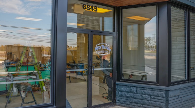 Josh Blake does construction on the upcoming Nifty Thrifties Bargain Bins on Friday, October 31, 2025, in Enon. The store is planned to open in November. JOSEPH COOKE/STAFF