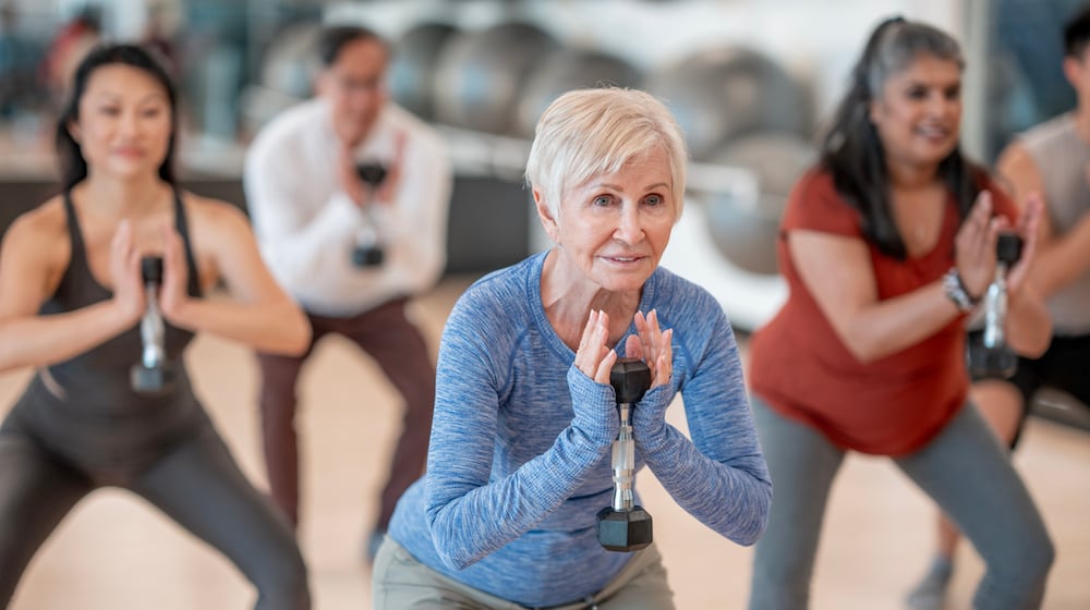 Individuals participates in a strength training session at a fitness studio. ISTOCK