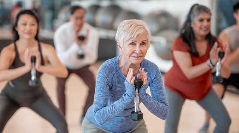 Individuals participates in a strength training session at a fitness studio. ISTOCK