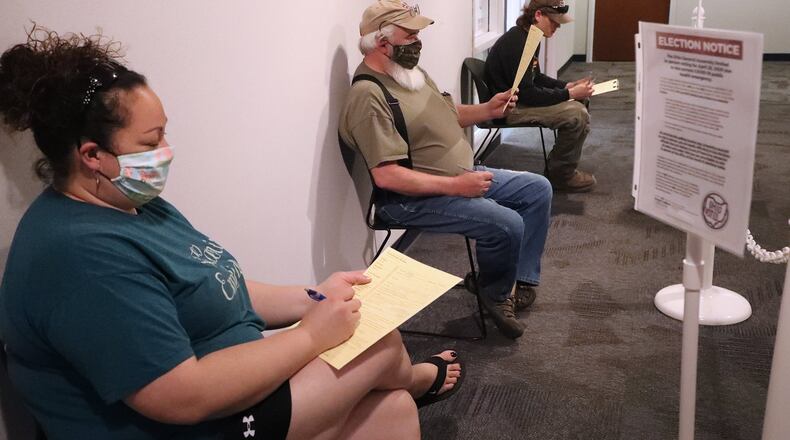 Voters wait outside the Champaign County Board of Elections during the April election. BILL LACKEY/STAFF