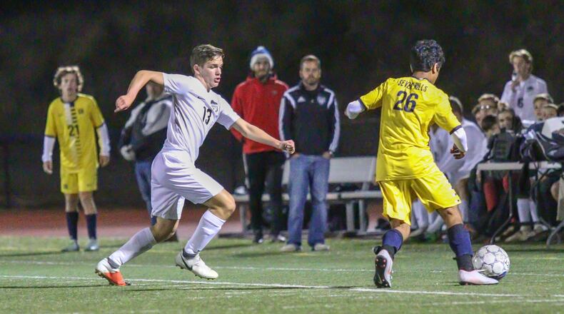Greenon’s Masonn Hayslip runs after Cincinnati Seven Hills defender Kayzad Bharucha during their Division III district final match at Monroe High School on Thursday night. The Stingers won 5-1. CONTRIBUTED PHOTO/MICHAEL COOPER