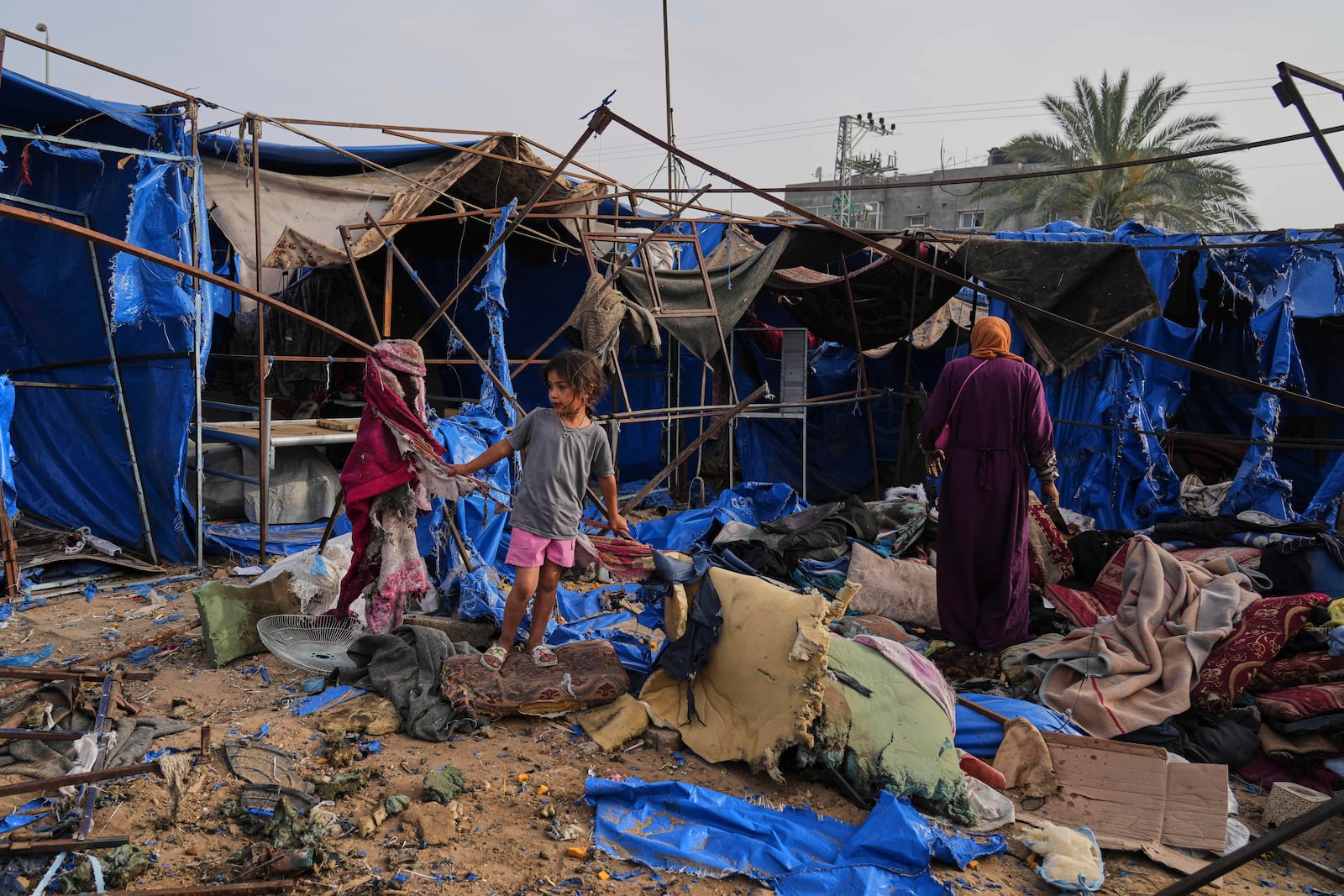 Palestinians inspect the damage caused by an Israeli airstrike that struck tents at Al-Aqsa Hospital in Deir al-Balah, central Gaza Strip, Saturday, May 17, 2025. (AP Photo/Abdel Kareem Hana)
