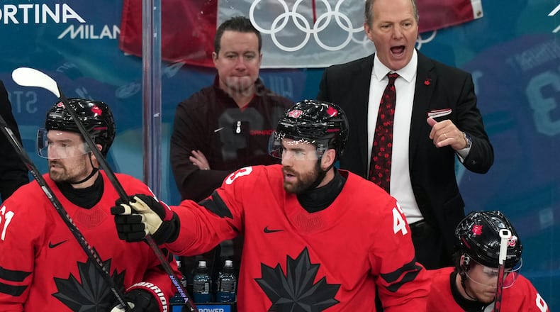 Canada head coach Jon Cooper, top right, directs his players during the first period of the men's ice hockey gold medal game against the United States at the 2026 Winter Olympics in Milan, Italy, Sunday, Feb. 22, 2026. (AP Photo/Carolyn Kaster)