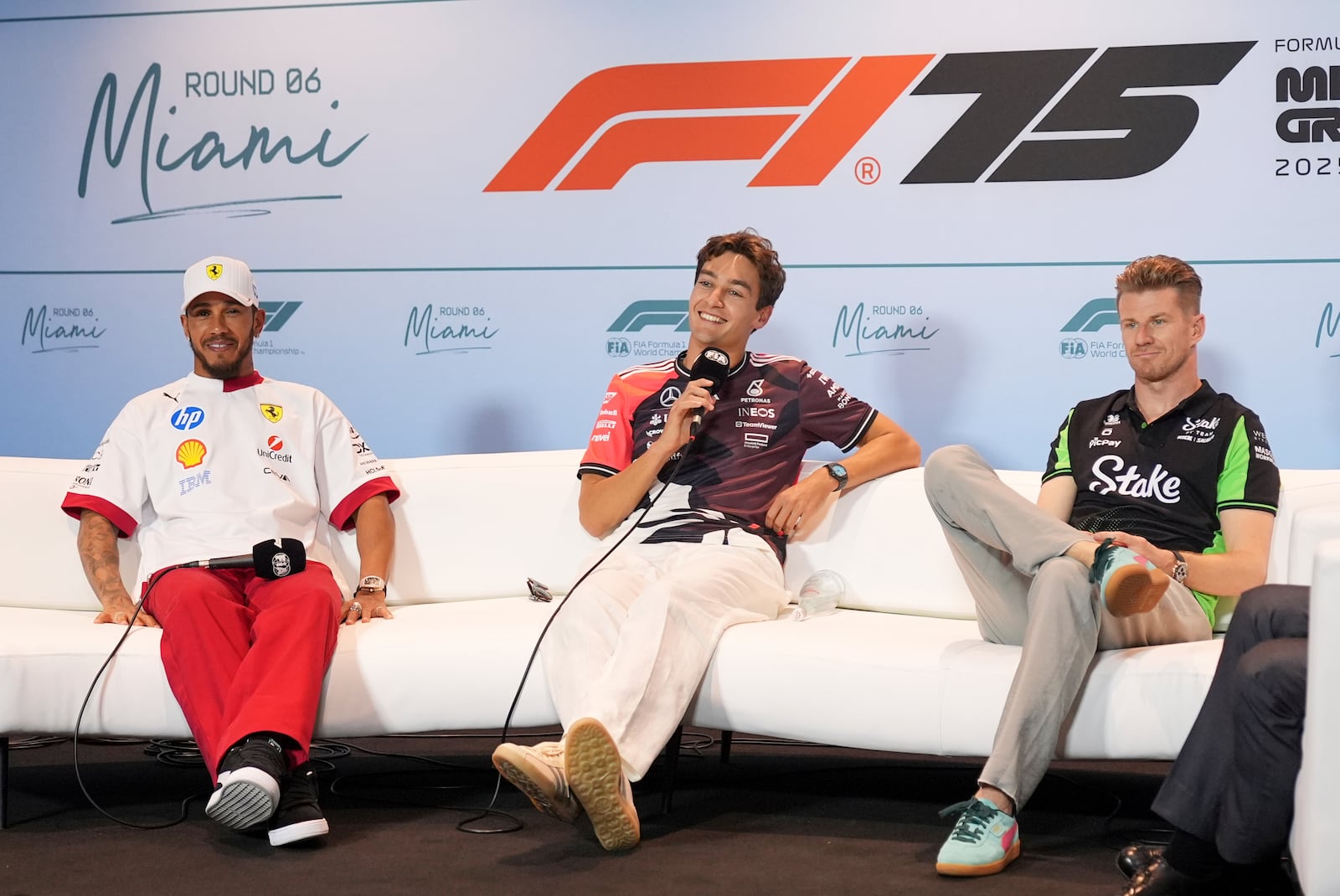 Mercedes driver George Russell, center, of Britain, answers a question as Ferrari driver Lewis Hamilton. left, also of Britain and Kick Sauber driver Nico Hulkenberg, right, of Germany, listen during a news conference ahead of the Formula One Miami Grand Prix auto race, Thursday, May 1, 2025, in Miami Gardens, Fla. (AP Photo/Rebecca Blackwell)
