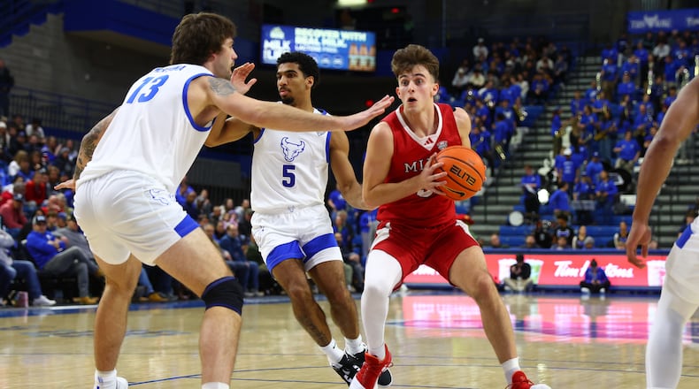 Miami (OH) guard Luke Skaljac (3) drives to the net infront pf Buffalo forward Ezra McKenna (13) during the first half of an NCAA college basketball game Tuesday, Feb. 3, 2026, in Buffalo, N.Y. (AP Photo/Jeffrey T. Barnes)
