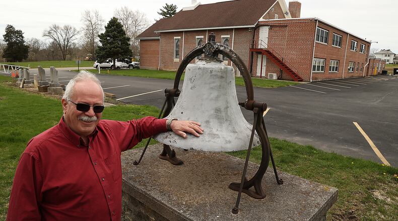 Bob Suver stands next to the bell from the original Bethel Baptist Church Wednesday, April 20, 2022. The church is celebrating it's 200th anniversary this Sunday, April 24. The church has been in the same location along New Carlisle Pike the entire 200 years. BILL LACKEY/STAFF