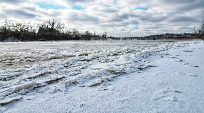 Ice forms on the surface of the Great Miami River at Combs Park in Hamilton Tuesday, Jan. 16, 2024, after several days of below freezing temperatures. NICK GRAHAM/STAFF