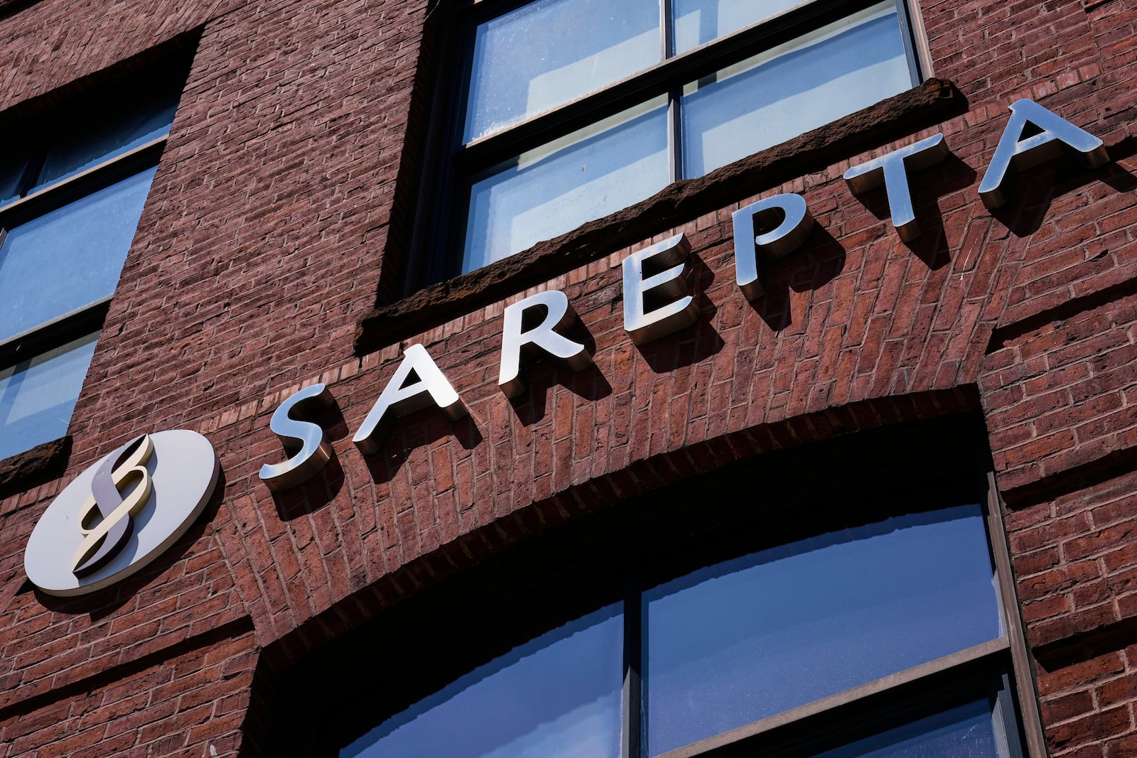 The name and logo of Sarepta Therapeutics is displayed on the company's headquarters, Monday, July 28, 2025, in Cambridge, Mass. (AP Photo/Charles Krupa)
