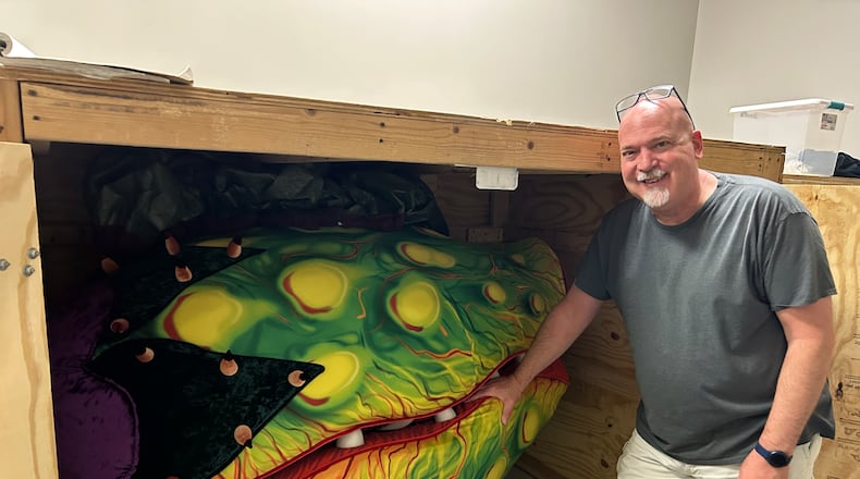 Director Troy Berry stands beside one of the puppet props of Audrey II for the John Legend Theater's upcoming production of "Little Shop of Horrors" coming to the theater on Friday, Aug. 1 and Saturday, Aug. 2. CONTRIBUTED