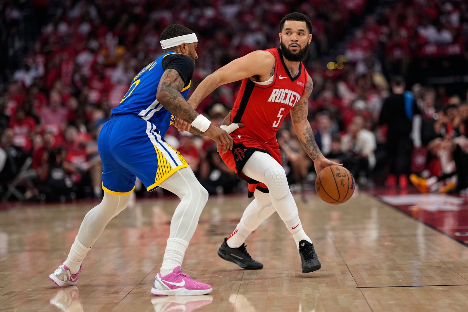 Houston Rockets guard Fred VanVleet (5) moves the ball up court as Golden State Warriors guard Gary Payton II defends during the first half of Game 5 of an NBA basketball first-round playoff series, Wednesday, April 30, 2025, in Houston. (AP Photo/David J. Phillip)