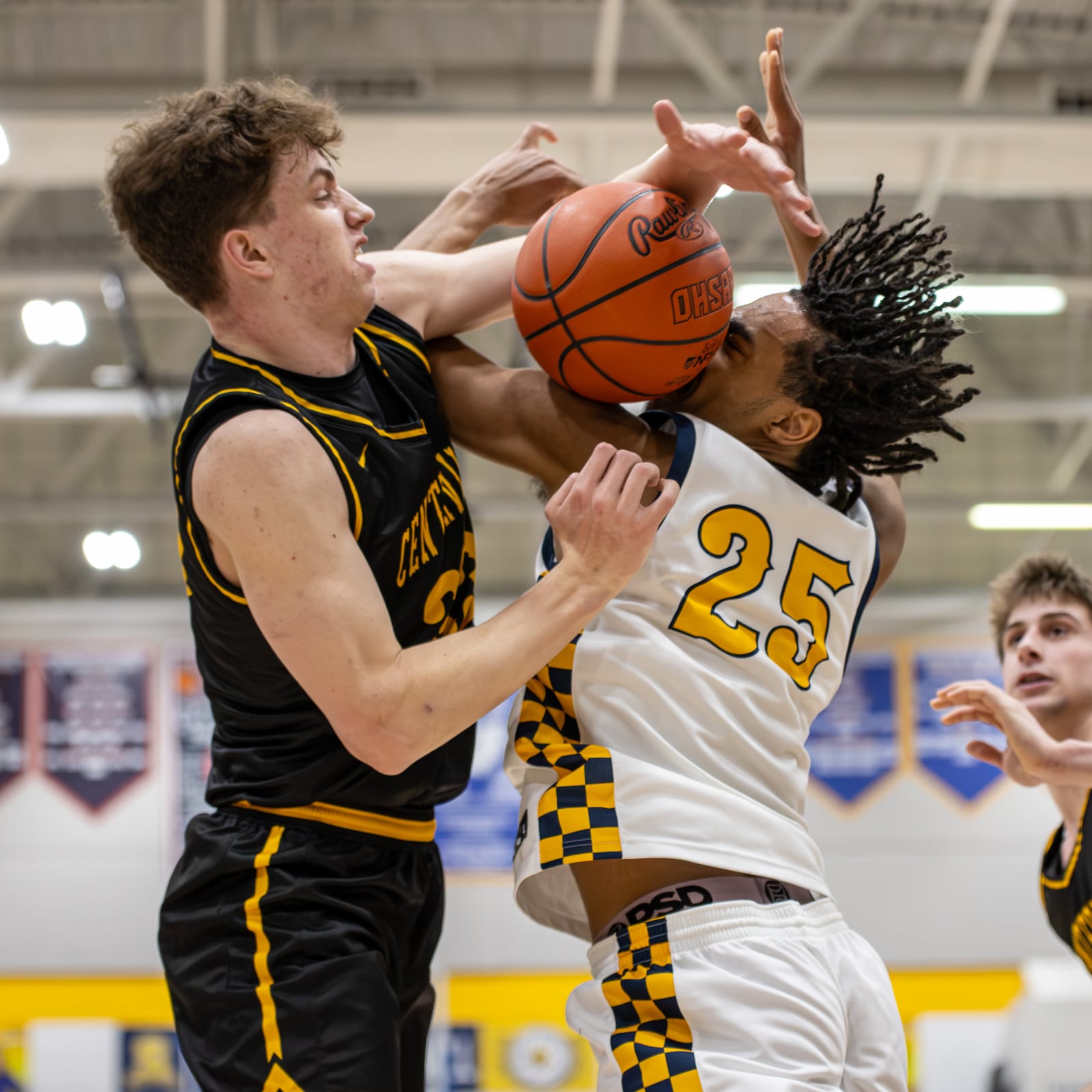 Centerville's Spencer Maxwell blocks a shot from Springfield's EJ Rice during their Greater Western Ohio Conference game on Tuesday, Feb. 3, 2026. The Elks won 56-44. MICHAEL COOPER / STAFF