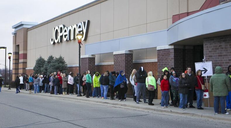 Holiday shoppers wait in line on Thanksgiving Day for early deals at JCPenney at the Bridgewater Falls shopping center, Thursday, Nov. 27, 2014. GREG LYNCH / STAFF