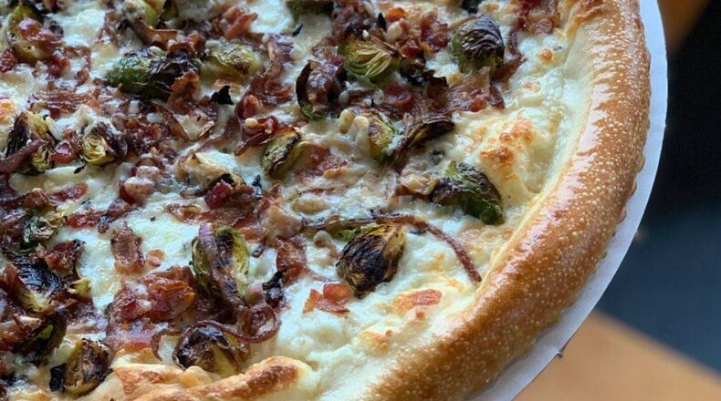 Dewey’s Van Damme pizza features Brussels sprouts tossed in truffle oil, bacon, beer braised onions and parmesan cheese. The pizza is available through Dec. 12. CONTRIBUTED PHOTO