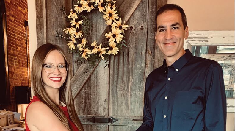 Bonnie Rutledge shakes hands with the previous owner of the Harrison New-Herald to make her ownership official. Contributed