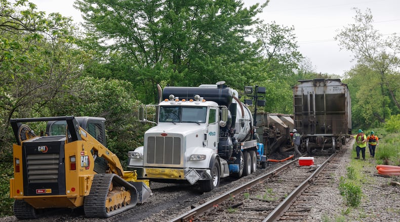 Crews work on a railroad track near Buck Creek on Wednesday, May 14, 2025, as part of continued cleanup following Tuesday's partial train derailment. JOSEPH COOKE/STAFF