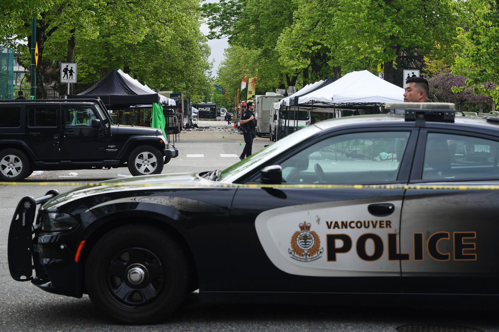 Vancouver Police survey the scene after a driver killed multiple people Saturday during a Filipino community festival Sunday, April 27, 2025, in Vancouver, British Columbia. (AP Photo/Lindsey Wasson)