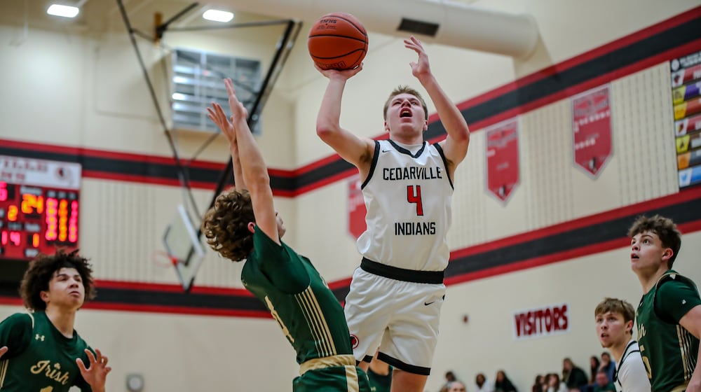 Cedarville High School senior Will Mossing shoots the ball over Catholic Central's Berkeley Little during their game on Friday, Jan. 9 in Cedarville. CONTRIBUTED PHOTO