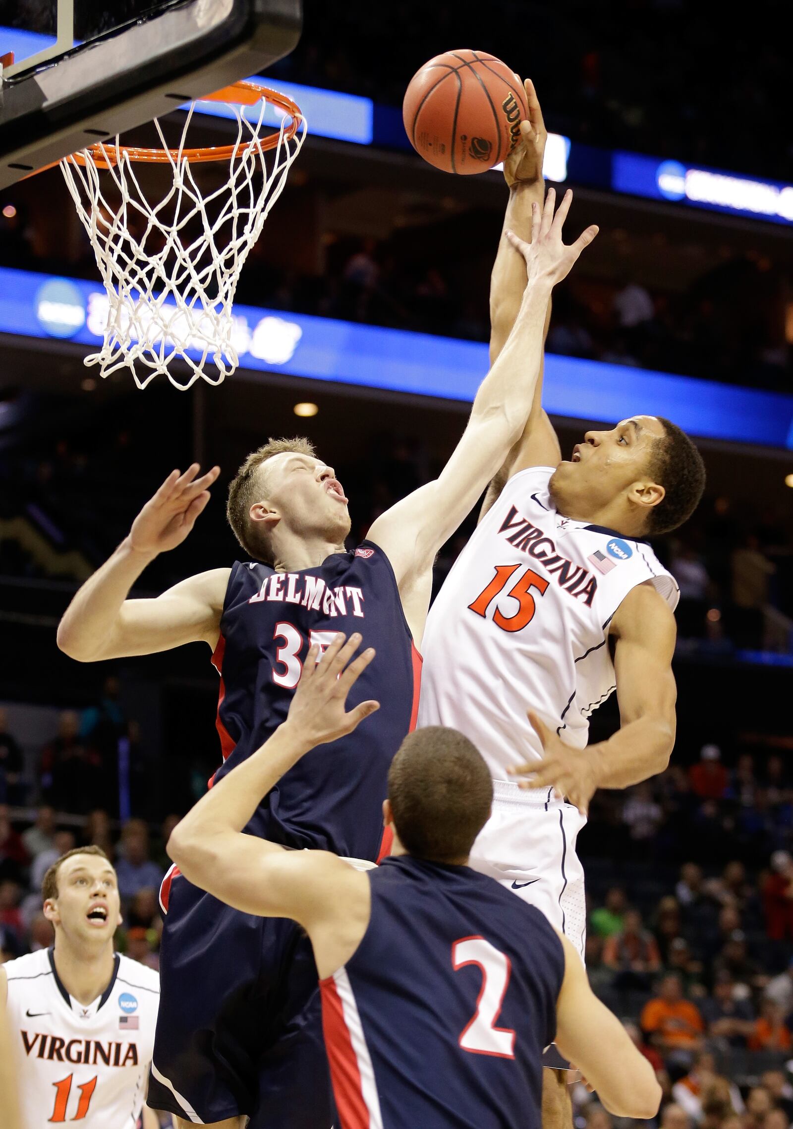 CHARLOTTE, NC - MARCH 20: Malcolm Brogdon #15 of the Virginia Cavaliers tries to dunk on Evan Bradds #35 of the Belmont Bruins during the second round of the 2015 NCAA Men’s Basketball Tournament at Time Warner Cable Arena on March 20, 2015 in Charlotte, North Carolina. (Photo by Bob Leverone/Getty Images)