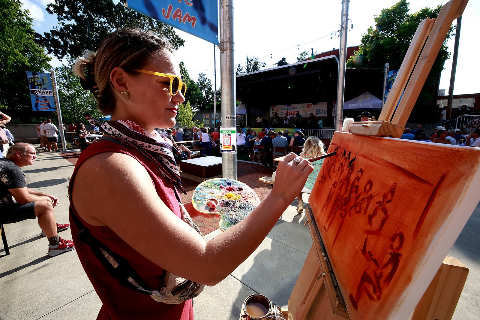 Artist Holly Hammeren paints the stage at Mother Stewart's as the Mother's Jazz Collective plays for the third annual Springfield Jazz & Blues Fest Friday, August 9, 2024. The musical event, at National Road Commons park and Mother Stewart's Brewing Co., is presented by the Springfield Kiwanis and features 18 acts featuring national, regional and local performers. The event will continue through Saturday evening. BILL LACKEY/STAFF