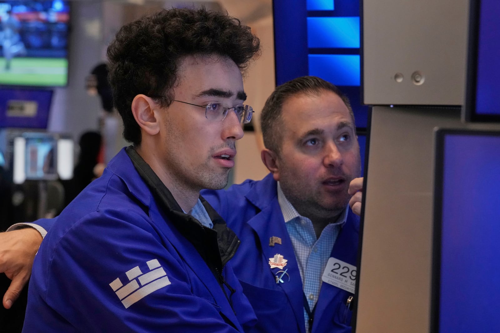 Specialists Alex Weitzman, left, and Gennaro Saporito work on the floor of the New York Stock Exchange, Thursday, May 1, 2025. (AP Photo/Richard Drew)