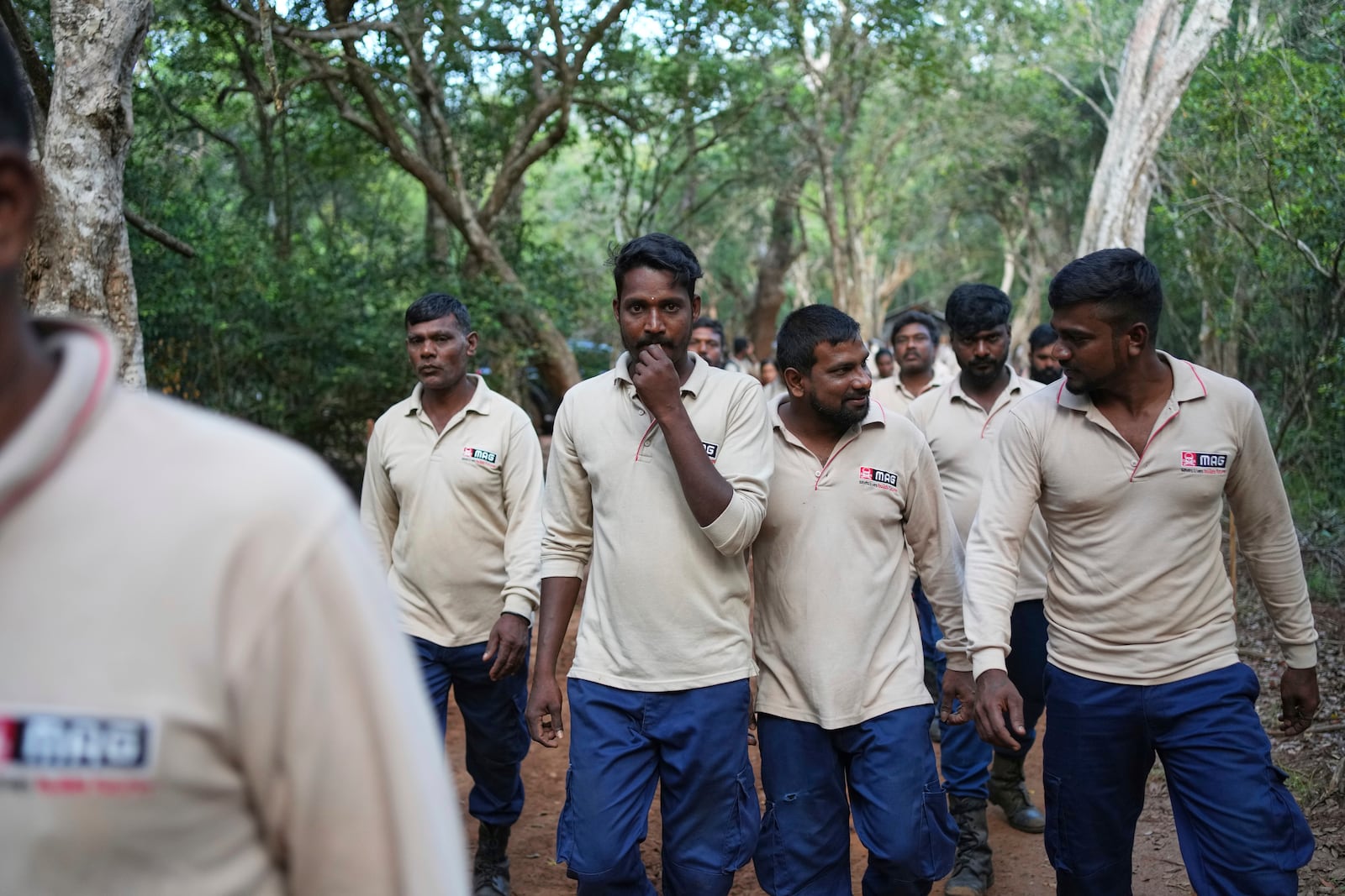 Vilvaraj Vinothan, second left, who works for the demining agency Mine Advisory Group, arrives with fellow workers to report at work before entering a contaminated mining area in Mankulam, Sri Lanka, Wednesday, April 2, 2025. (AP Photo/Eranga Jayawardena)
