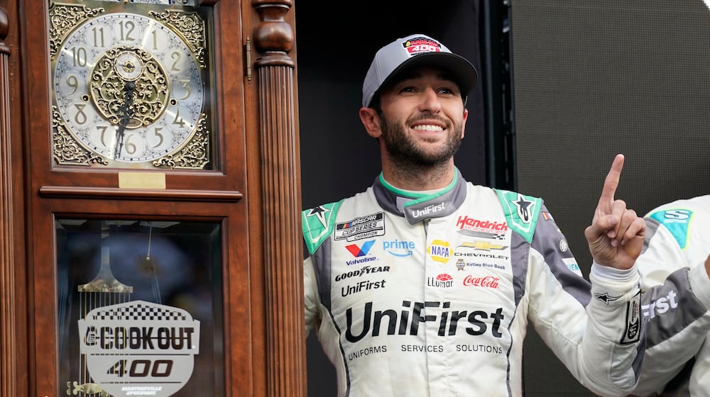 Chase Elliott poses with the trophy in Victory Lane after winning a NASCAR Cup Series auto race in Martinsville, Va., Sunday, March 29, 2026. (AP Photo/Chuck Burton)