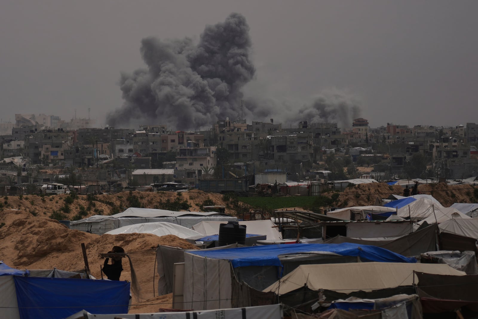 Smoke rises to the sky following an Israeli bombardment in Khan Younis, Gaza Strip, Thursday, April 24, 2025. (AP Photo/Abdel Kareem Hana)