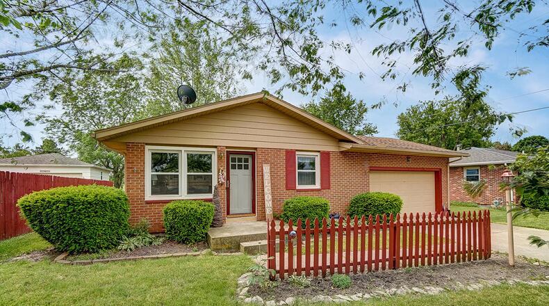 The front of this brick ranch home features a wood, decorative fence, a new front door and an attached, 2-car garage. The 3-bedroom home offers about 1,125 sq. ft. of living space and a full, partially finished basement. CONTRIBUTED PHOTO