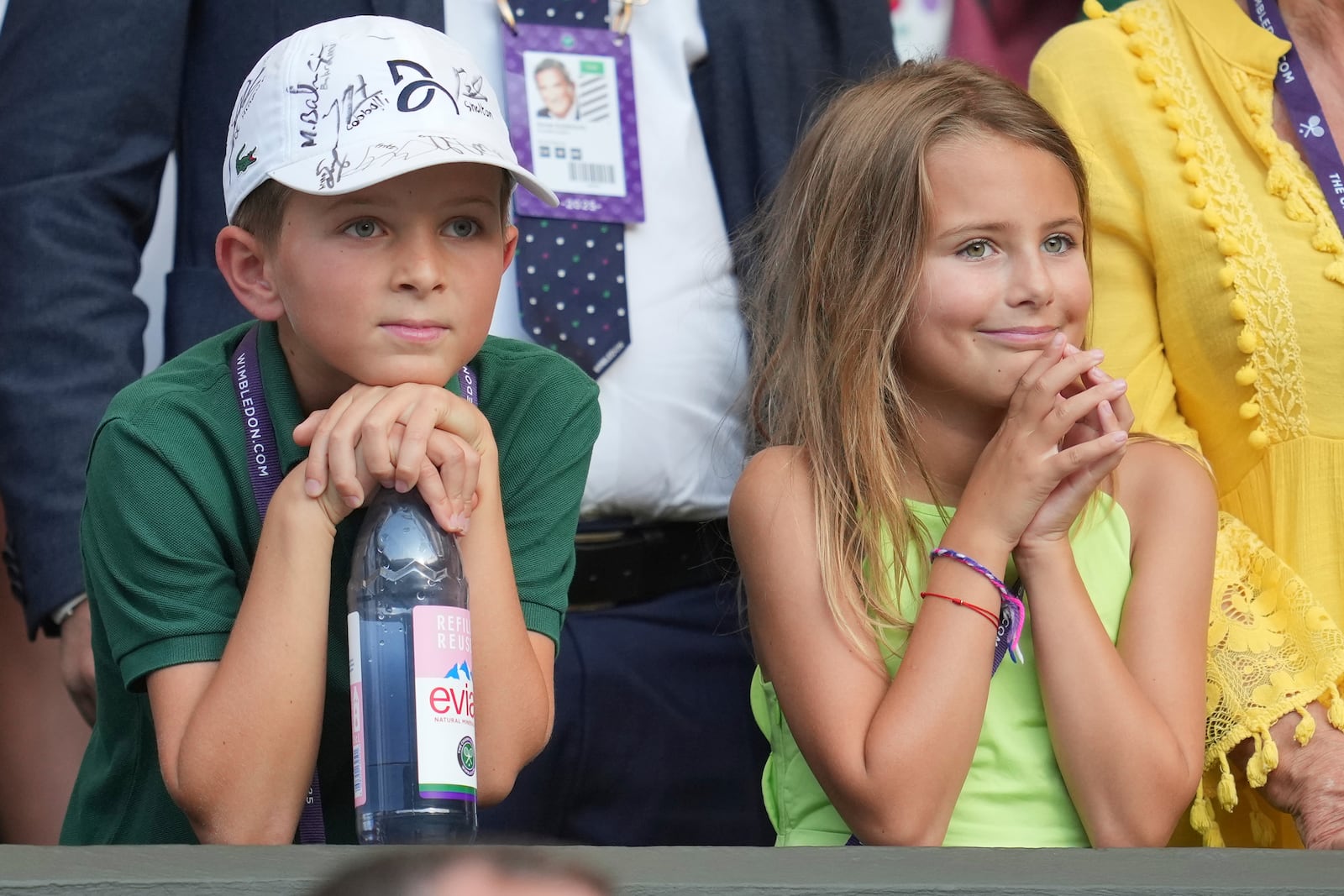 Stefan and Tara, the children of Serbia's Novak Djokovic smiles after their father beat Italy's Flavio Cobolli in a quarterfinal men's singles match at the Wimbledon Tennis Championships in London, Wednesday, July 9, 2025. (AP Photo/Kin Cheung)