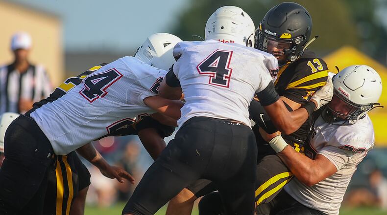 A group of Greenon High School defenders bring down Shawnee's Zane Mercer during their scrimmage game on Friday, Aug. 13 in Springfield. CONTRIBUTED PHOTO BY MICHAEL COOPER