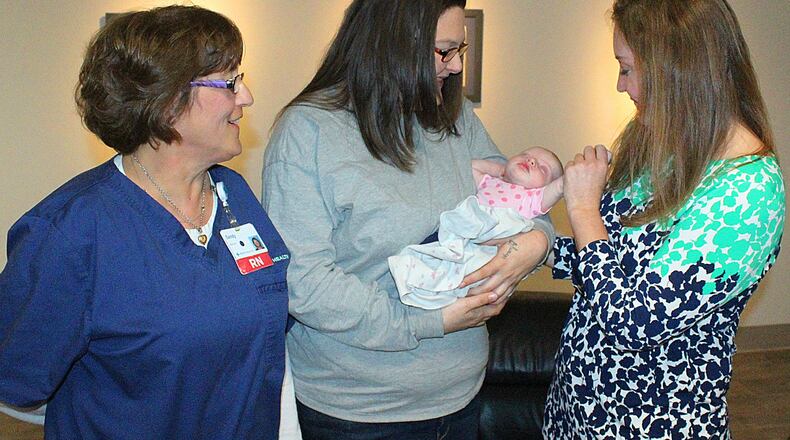 Heidi Tuttle holds her daughter Faith while MERCYHEALTH Urbana Hospital nurses (left) Sandy Hess and Tricia Blanken look on. JEFF GUERINI/STAFF