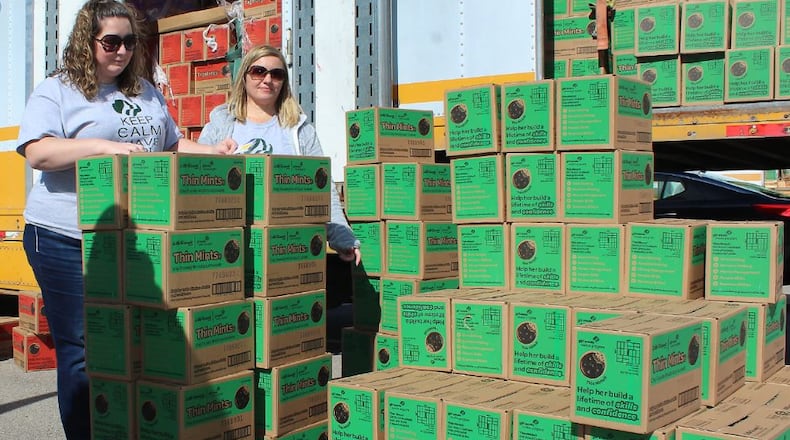 Kimberley Cooley and (right) Amber Brown with Girl Scout Troop 34111 wait to load their cookies at the Clark County Fairgrounds. JEFF GUERINI/STAFF