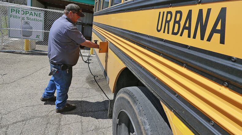 Benji Orahod, an employee of Heritage Cooperative in Urbana, fills up one Urbana school buses with propane Wednesday. Urbana City Schools currently has three propane buses in its fleet. Bill Lackey/Staff