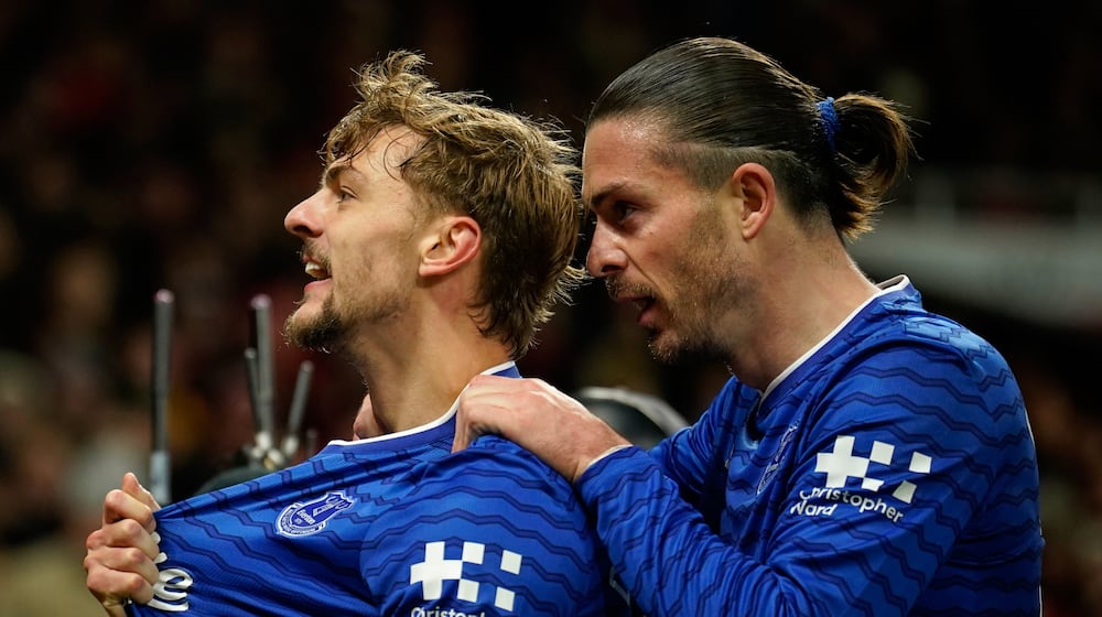 Everton's Kiernan Dewsbury-Hall, left, celebrates with Jack Grealish after scoring the opening goal during the English Premier League soccer match between Manchester United and Everton in Manchester, England, Monday, Nov. 24, 2025. (AP Photo/Dave Thompson)