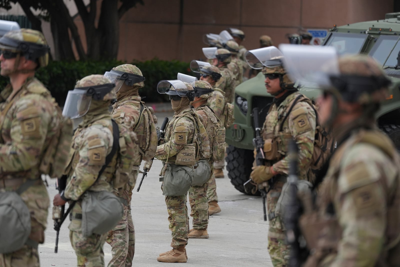 U.S. National Guard are deployed outside the federal prison in downtown Los Angeles, Sunday, June 8, 2025, following a immigration raid protest the night before. (AP Photo/Jae Hong)
