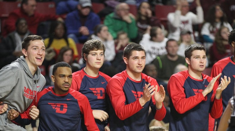 Dayton players react to a play during a game against Massachusetts on Saturday, Feb. 3, 2018, at the Mullins Center in Amherst, Mass. From left to right, they are: Ryan Mikesell, Camron Greer, Dalton Stewart, Jack Westerfield and Joey Gruden. David Jablonski/Staff
