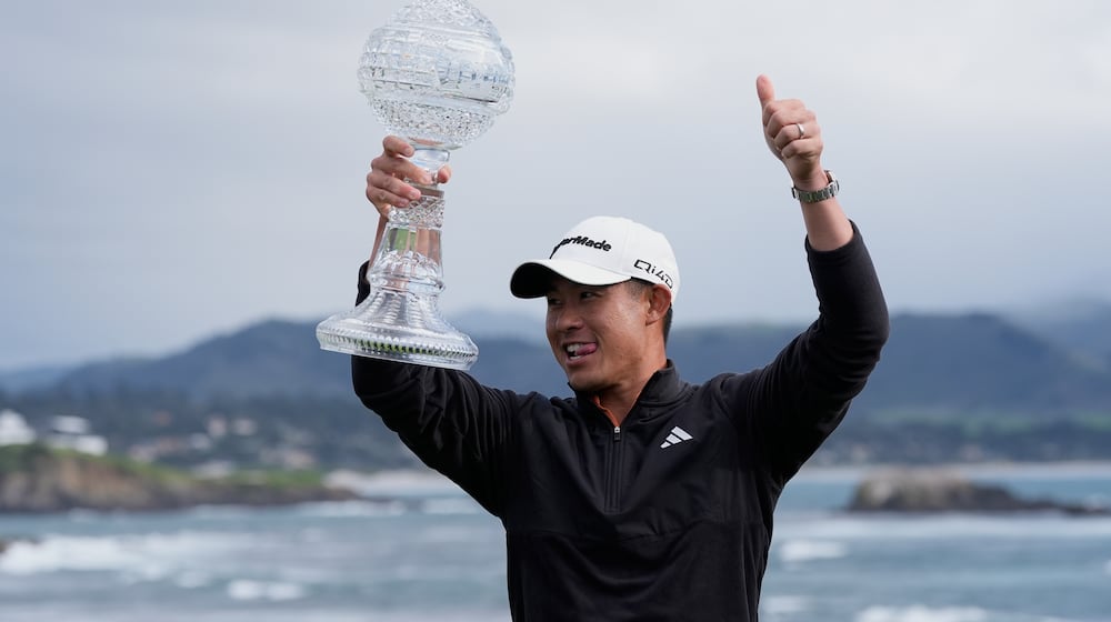 Collin Morikawa celebrates at Pebble Beach Golf Links after winning the AT&T Pebble Beach Pro-Am golf tournament in Pebble Beach, Calif., Sunday, Feb. 15, 2026. (AP Photo/Godofredo A. Vásquez)