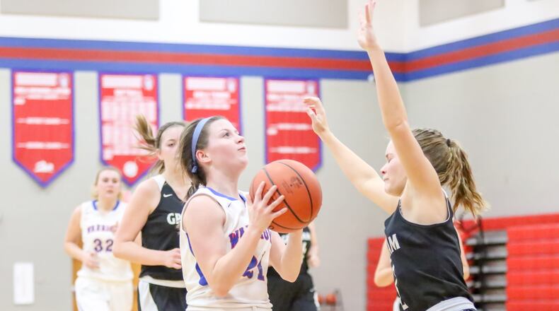 Northwestern High School’s Miranda Gillman drives to the hoop as Graham’s Lexi Neeld prepares to take a charge during their game in Springfield on Monday night. The Warriors won 36-29. CONTRIBUTED PHOTO BY MICHAEL COOPER