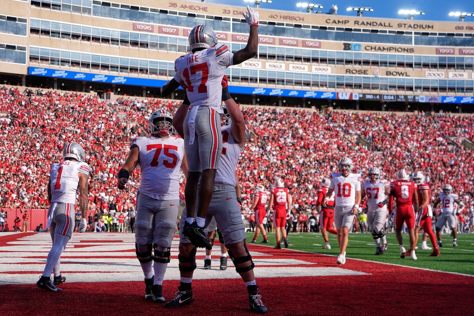 Ohio State's Joshua Padilla lifts Carnell Tate after a topuchdown catch during the first half of an NCAA college football game against the Wisconsin Saturday, Oct. 18, 2025, in Madison, Wis. (AP Photo/Morry Gash)
