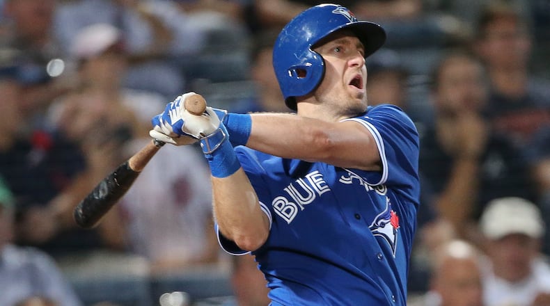 Toronto Blue Jays second baseman Cliff Pennington follows through on a three-run home run during the fourth inning of a baseball game against the Atlanta Braves on Thursday, Sept. 17, 2015, in Atlanta. (AP Photo/John Bazemore)