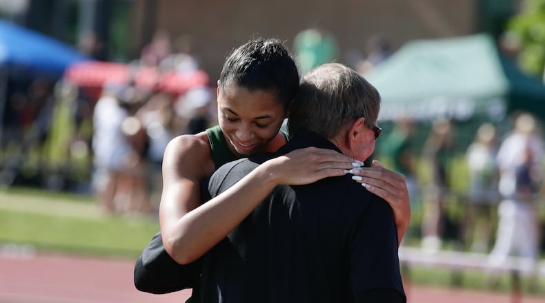 Catholic Central's Mallory Mullen hugs her coach Mark Klopfenstein after her final jump in her victory in the high jump in the Division III state track championship on Friday, June 3, 2022, at Jesse Owens Memorial Stadium in Columbus. David Jablonski/Staff