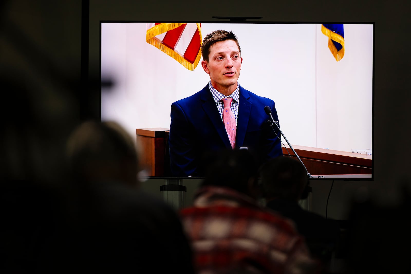 Members of the media watch a live stream as former Grand Rapids Police officer Christopher Schurr testifies during his fifth day of trial at the Kent County Courthouse in Grand Rapids, Mich. on Friday, May 2, 2025. (Joel Bissell /Kalamazoo Gazette via AP)