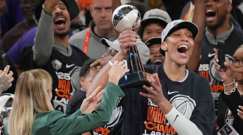 FILE - Las Vegas Aces center A'ja Wilson, center right, holds up her MVP trophy after Game 4 of the WNBA basketball finals against the Phoenix Mercury, Friday, Oct. 10, 2025, in Phoenix. (AP Photo/Rick Scuteri, File)