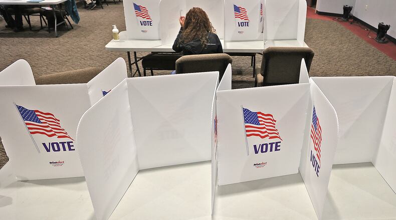 A woman casts her vote at Church on Middle Urbana Road in Clark County. BILL LACKEY/STAFF