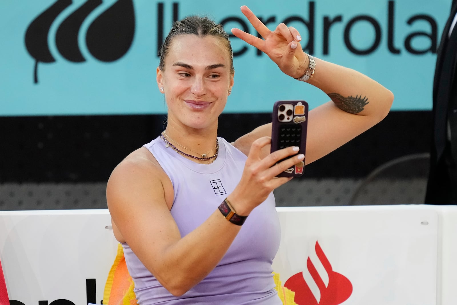 Aryna Sabalenka of Belarus makes a selfie after winning the Madrid Open tennis final against United States' Coco Gauff in Madrid, Spain, Saturday, May 3, 2025. (AP Photo/Jose Breton)